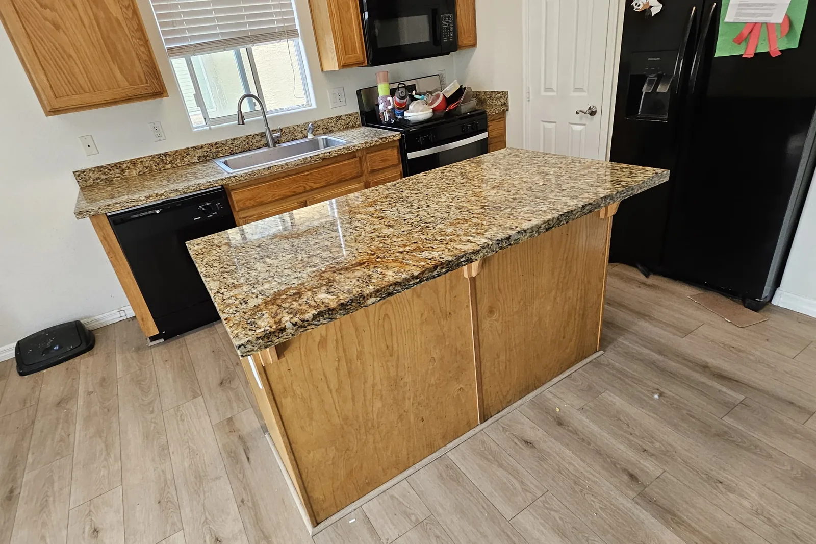 Granite kitchen island restored to an even polished finish