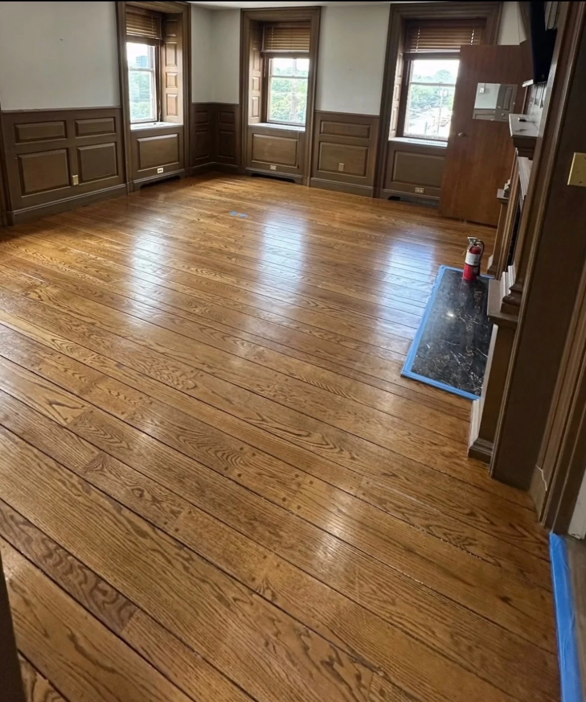 Existing hardwood floor with its stain and character preserved after surface care