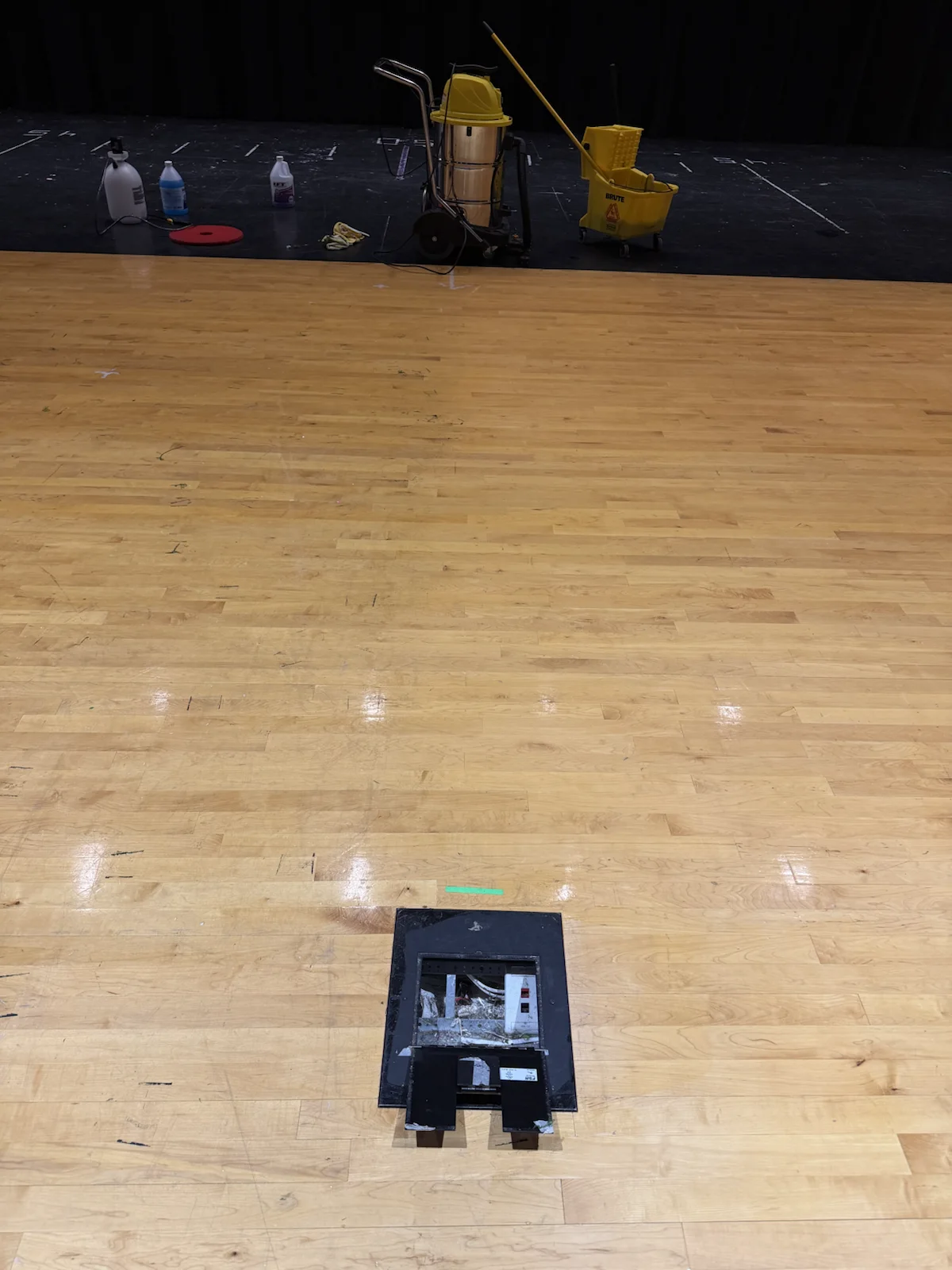 Professional floor-care equipment working across a hardwood surface