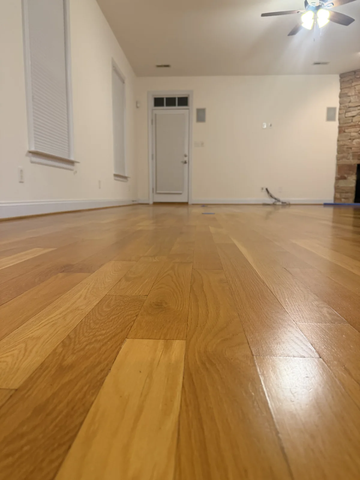 After: the same oak floor with the buildup removed and a fresh polyurethane coat