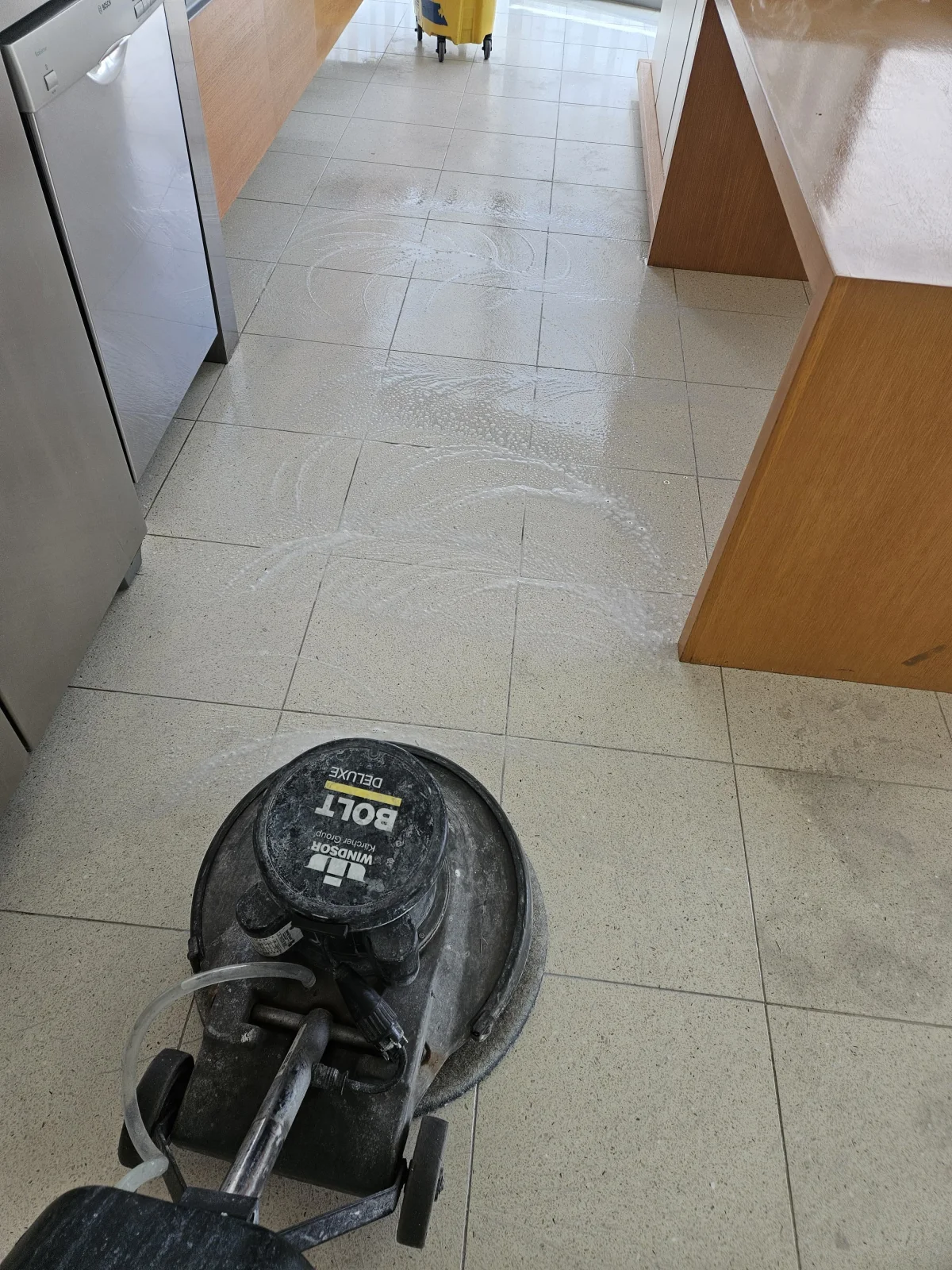 Rotary cleaning machine working across the real tiled floor