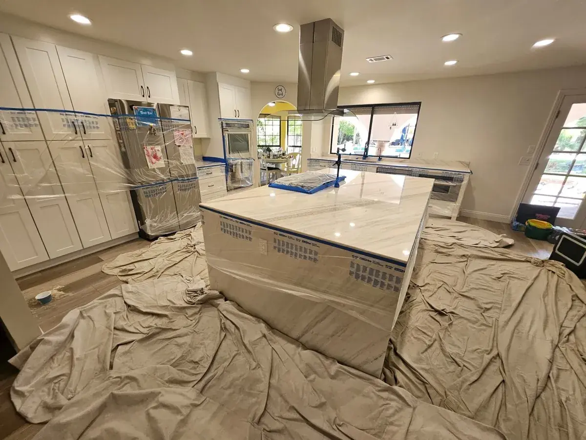 Stone countertop restoration project with the surrounding kitchen protected during work