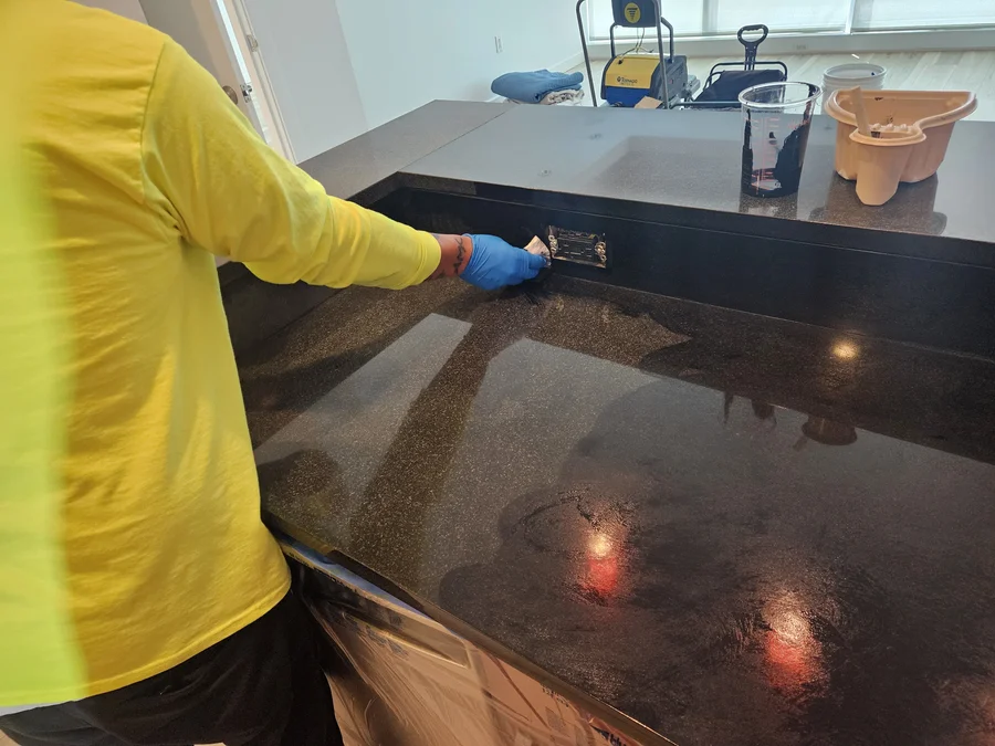 Protective sealer applied evenly across a real black granite countertop