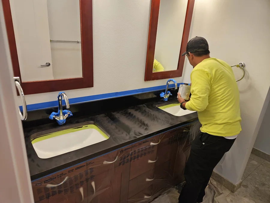 Fixtures and surrounding finishes masked before granite sealing