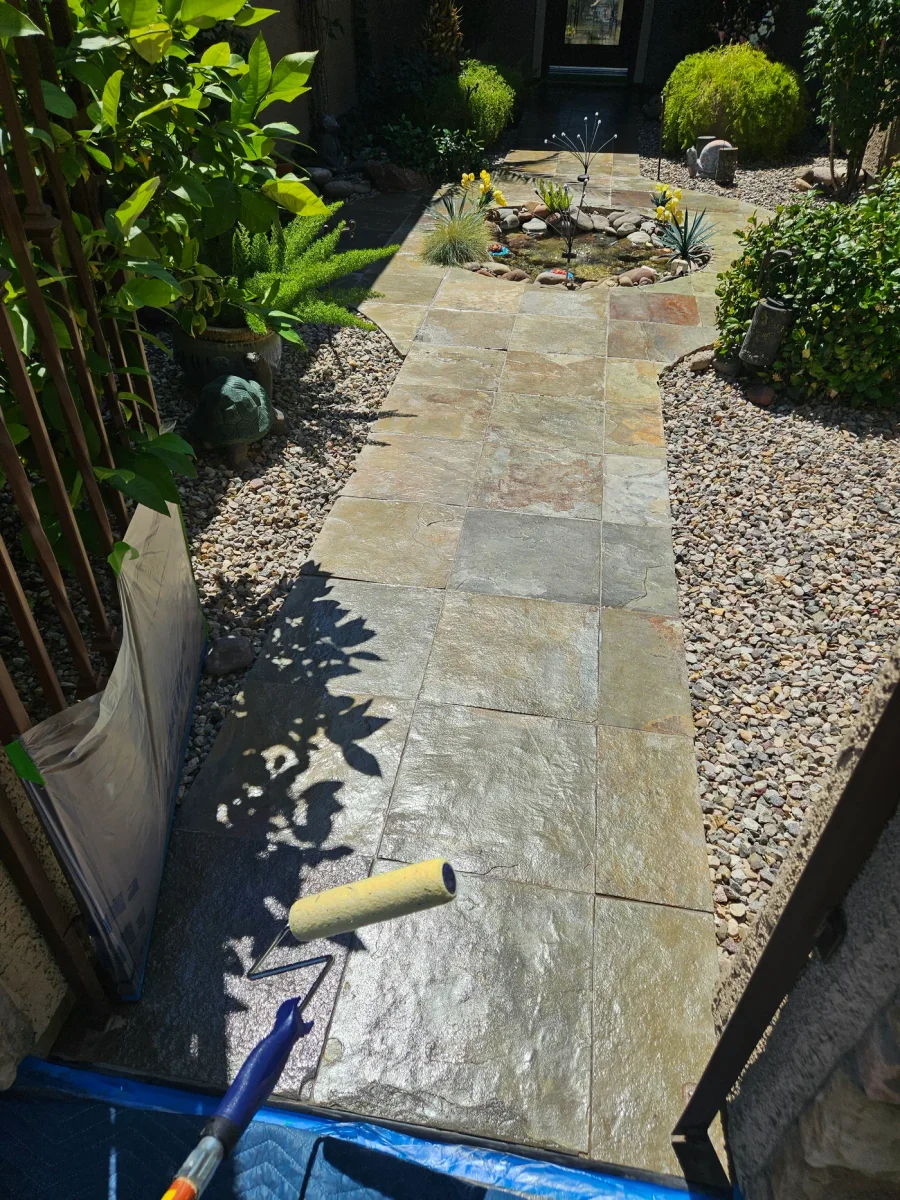 Protective sealer being applied evenly across cleaned joints and pavers