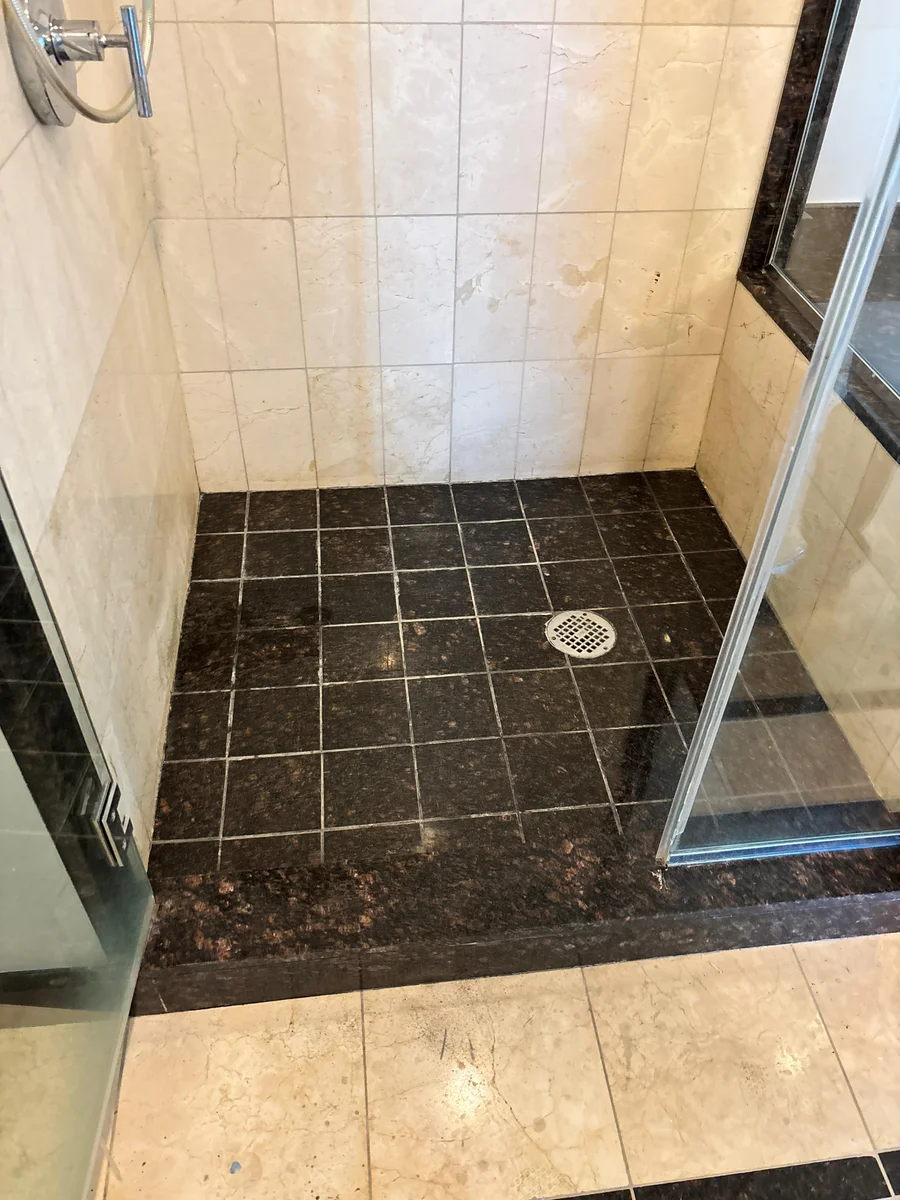 Clean shower-floor grout lines after professional service