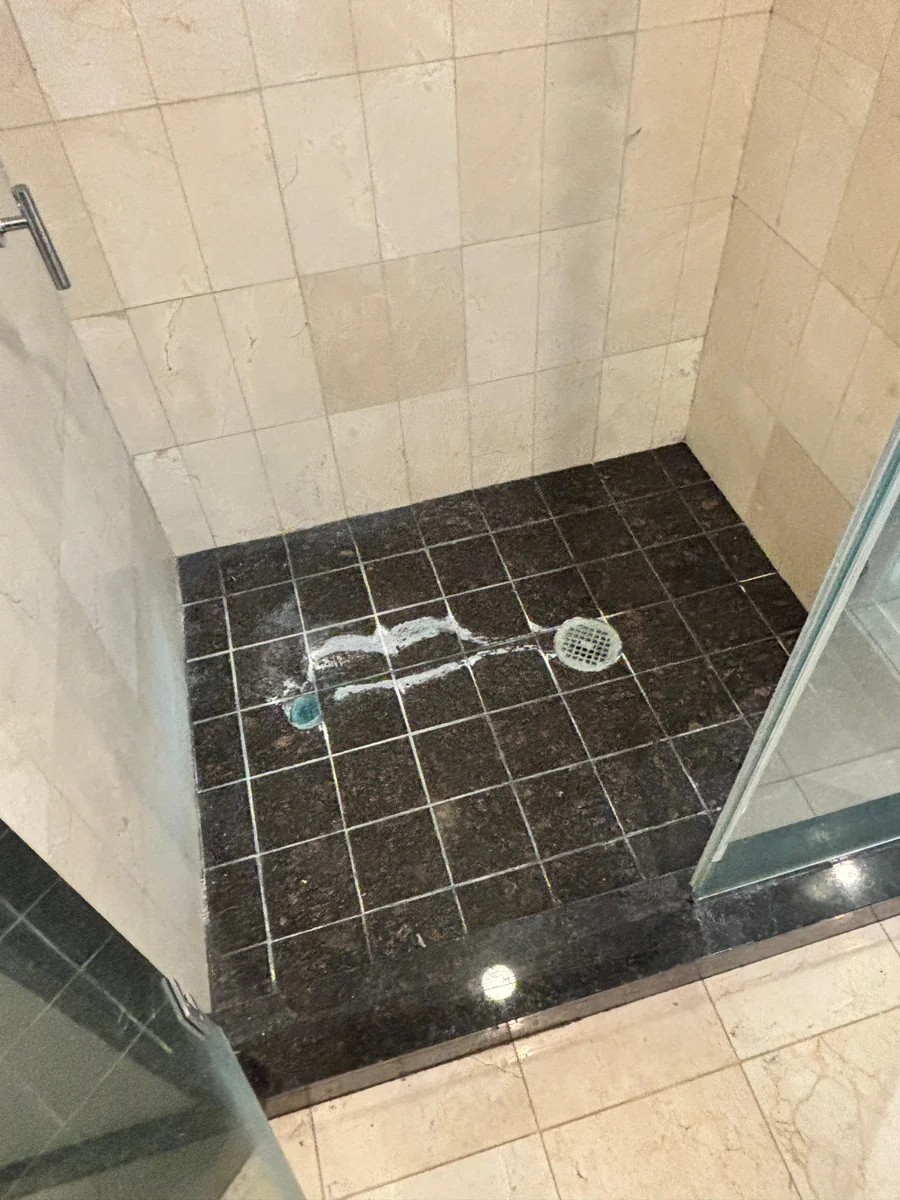 Discolored grout and hard-water buildup before professional cleaning