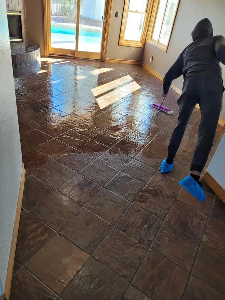Protective finish being applied evenly across a real slate floor