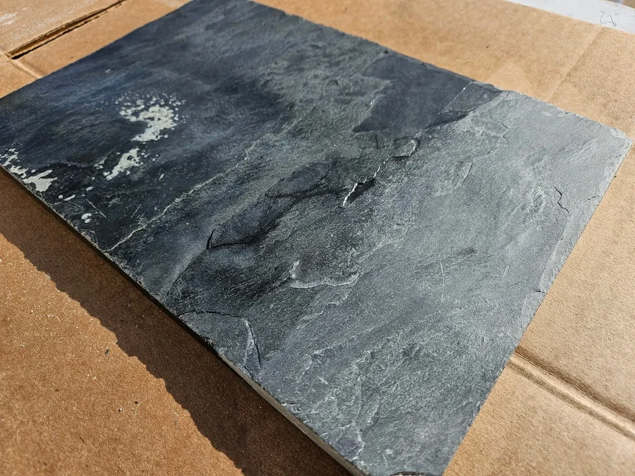 Natural stone tile sample showing the surface before full polishing