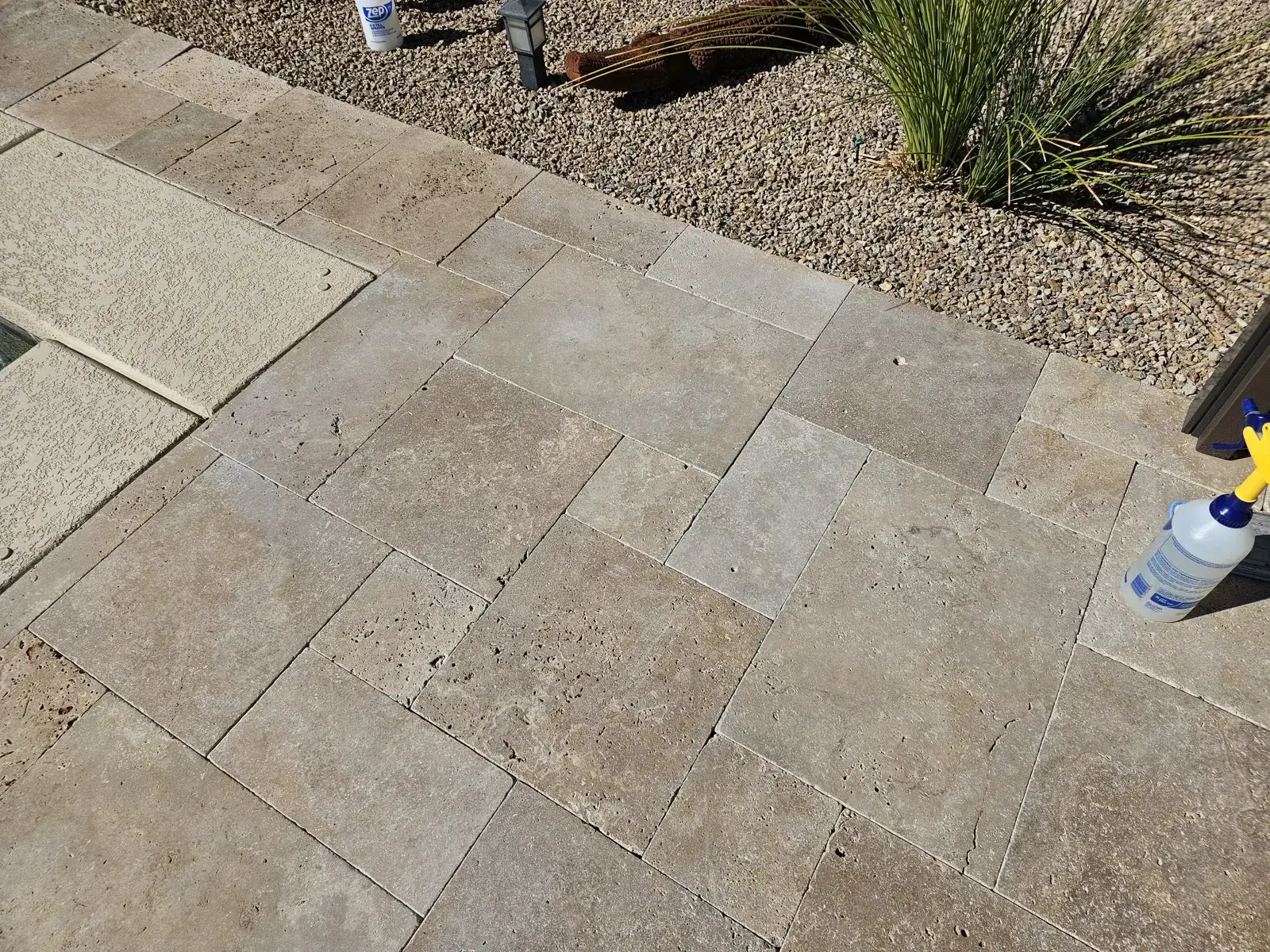 Real travertine pool deck showing embedded soil and uneven color before restoration